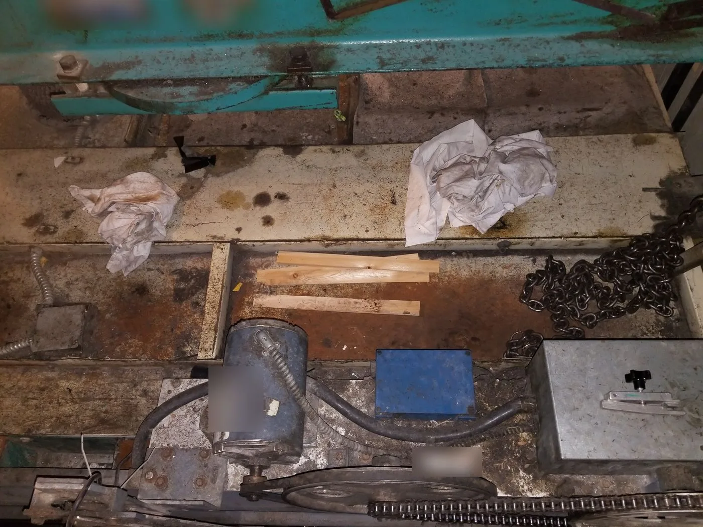 Elevator car top with rags, timber offcuts and a loose chain left lying on it
